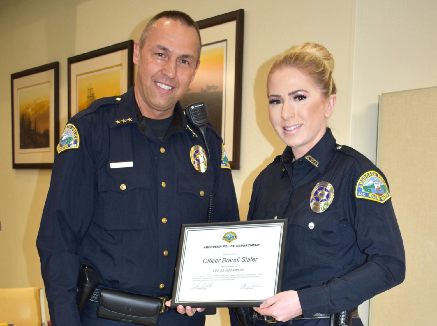 Aberdeen Police Department Chief Steve Shumate bestows the department’s “Lifesaving Award” to fellow APD Officer Brandi Slater after he relayed the story about the call that showed Slater’s mettle. Slater, who’s been with APD for five years, called her save on Thursday morning, Jan. 13, 2022, “a scary moment.”